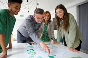 Mature businessman pointing at chart while brainstorming with colleagues in office during meeting